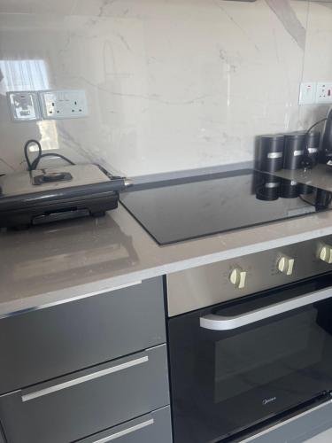 a kitchen with a stove and a counter top at New Apartmens in Iskele