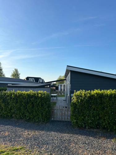 a house with a fence and a driveway at Mayas Ferienhaus in Lathum