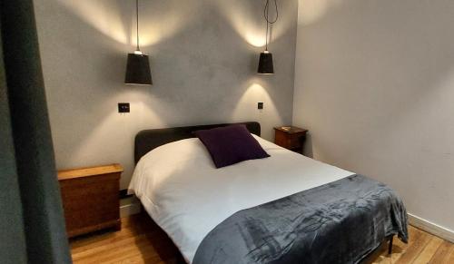 - une chambre avec un lit et deux lampes pendant dans l'établissement Burdigala Homes - L'Appart Place du Palais, à Bordeaux