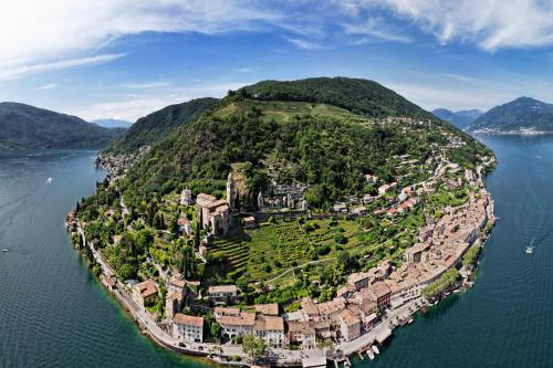 an island in the middle of the water at Gritti Palace Morcote - Waterfront studio with panoramic lake views - Fiordaliso in Morcote