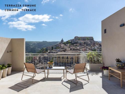 a balcony with a table and chairs with a view at La casa di Irene - Suites con vista in Ragusa