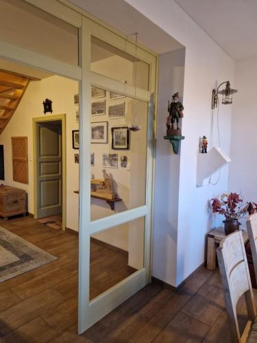 a sliding glass door in a room with a table at Hájovna u Jindřicha in Nová Pec