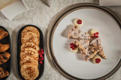 a white plate with pastries and bread on it at Grand Hotel San Marino in San Marino