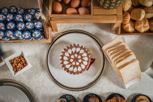 a table topped with a plate with a cake and bread at Grand Hotel San Marino in San Marino