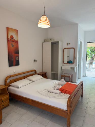a bedroom with a bed and a mirror in it at Fiore House in Parga