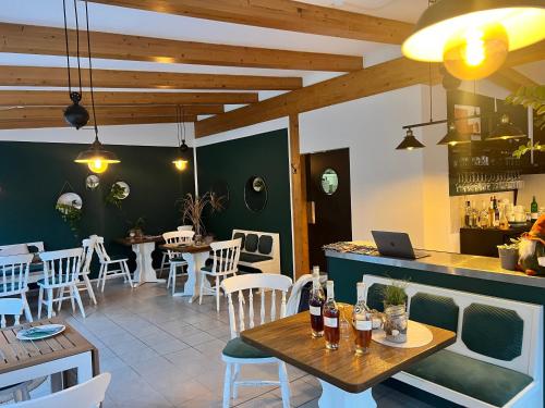 a restaurant with a table with a laptop on it at Villa Wiesenau by Restaurant WIESENAU in Prerow