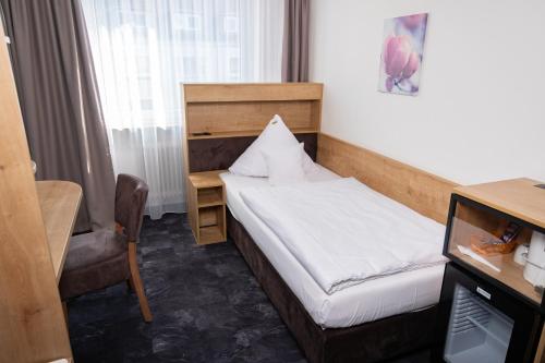 Ένα ή περισσότερα κρεβάτια σε δωμάτιο στο Hotel Alpha
