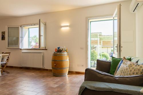 a living room with a couch and a barrel at Bioagriturismo Terra d'Angeli in Bagno Roselle
