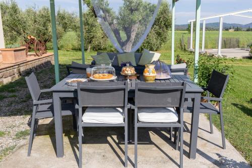 a black table and chairs with food on it at Bioagriturismo Terra d'Angeli in Bagno Roselle