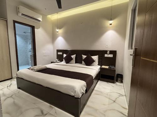 a bedroom with a large bed in a room at Hotel Casa in Chandīgarh