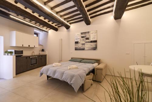 a bedroom with a bed and a kitchen at Suite n12 - Loft incantevole nel cuore di Perugia in Perugia