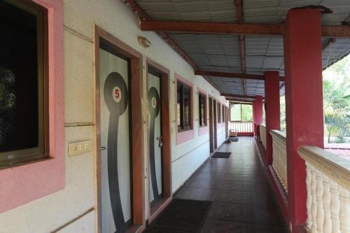 an empty hallway of a building with the number eight on it at Shree Samarth Krupa Beach Resort in Alibaug