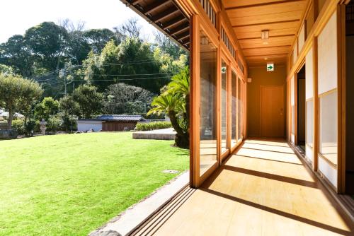 Una puerta abierta a una casa con un patio verde. en 鎌倉雅壇, en Kamakura