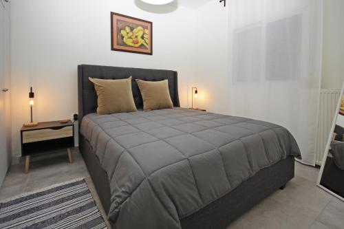 a bedroom with a bed and a side table at Kelyfos Sunset luxury apartment in Neos Marmaras
