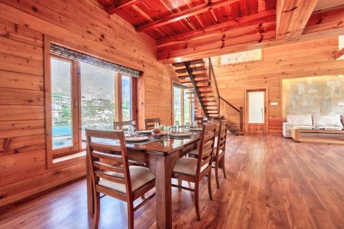 a dining room with a table and chairs at Mountain Chalet By Vivaan in Shamshi