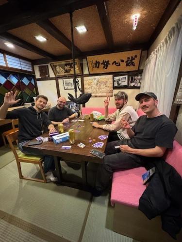 a group of people sitting around a table in a restaurant at Tsuyukusa in Takayama