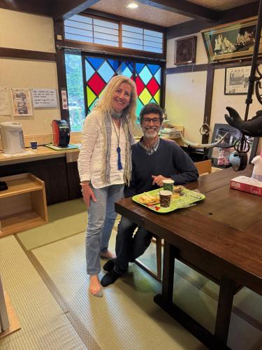 a woman standing next to a man sitting at a table at Tsuyukusa in Takayama