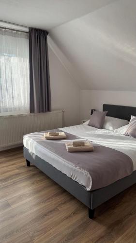 a bedroom with a bed with two towels on it at Privát Harenčár in Stará Lesná