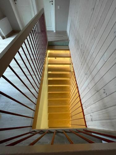 a spiral staircase in a building with yellow risers at River Mind Villa with SPA in Zalioji