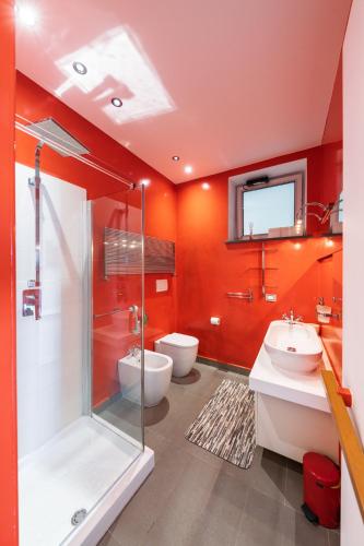 a bathroom with two toilets and a shower and a sink at The Loft Via Torricella in Ravello
