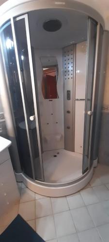 a bathroom with a walk in shower in a room at Résidence Marina Beach in M'diq