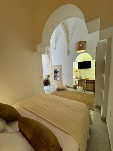 a bedroom with a large bed and a fireplace at Dar Benti in Monastir