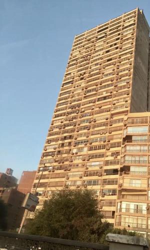 a tall building with windows on the side of it at Amazing Nile view luxury apartment with wifi in Cairo