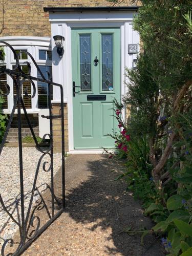 a green door on a house with a gate at Minster Cottage - Cathedral Quarter with Free Parking in Lincoln