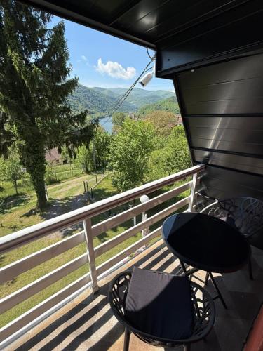 a balcony with a table and chairs and a view at Weekend getaway house in Goražde