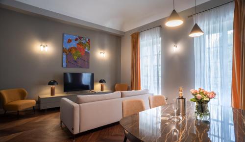 a living room with a couch and a table at Palazzo Del Carretto-Art Apartments and Guesthouse in Turin