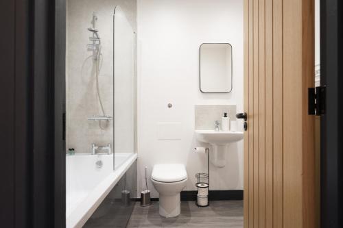 a bathroom with a toilet and a sink and a shower at EightySix Bondgate by Harrogate Serviced Apartments in Ripon