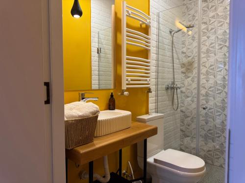 a bathroom with a sink and a toilet and a shower at Our Old House in Tʼelavi