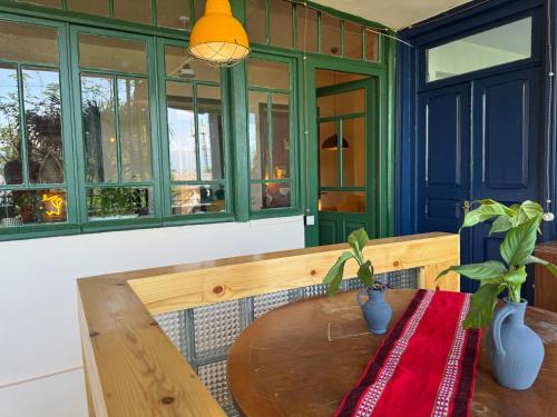 a room with a wooden bench with a table at Our Old House in Tʼelavi