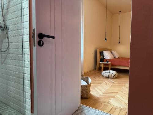 a bathroom with a shower and a bedroom with a bed at Our Old House in Tʼelavi