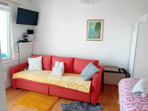 a red couch sitting in a living room at Holiday Home Nature Plesivica in Jastrebarsko