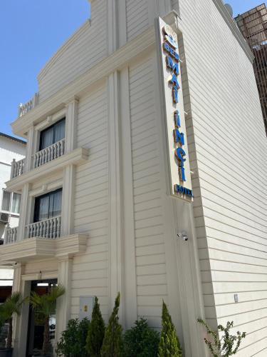 a building with a sign on the side of it at Ber Mai İnci Hotel Antalya in Antalya