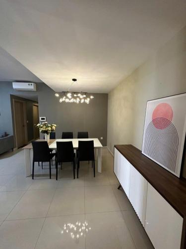 a dining room with a white table and chairs at Mina Homie in Ho Chi Minh City