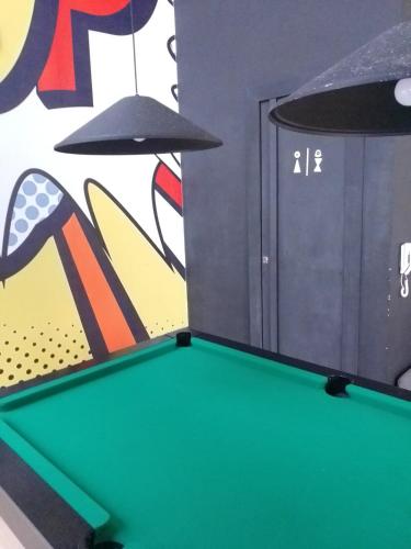 a pool table in a room with a wall at Piratininga - Niterói RJ in Niterói
