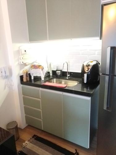 a kitchen with a sink and a refrigerator at Piratininga - Niterói RJ in Niterói