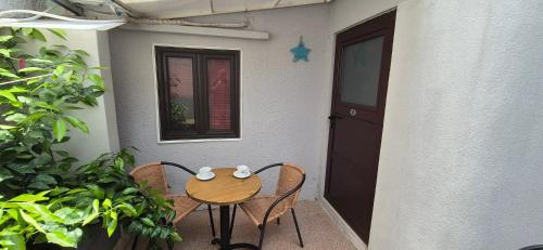 a small table and chairs in front of a house at Majka 2 Apartments in Kotor