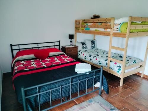 a bedroom with two bunk beds and a bed at Quinta de Canelas in Torre de Moncorvo