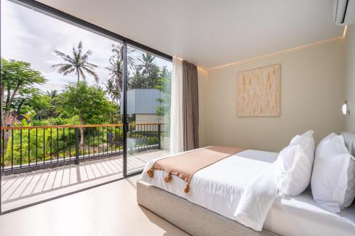 a bedroom with a bed and a large window at Hidden City Ubud - Modern Comfort & Relaxed Living near Central Ubud and Green Fields in Ubud