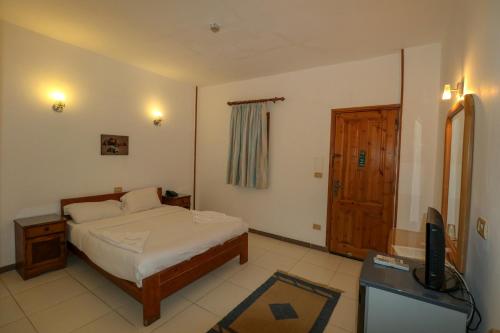 a bedroom with a bed and a television in it at Acacia Dahab Hotel in Dahab