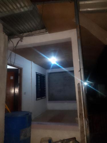 a room with a light on the wall at Glowing soul in Bañga
