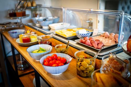 a buffet with different types of food on a table at bodenseezeit Apartmenthotel Garni in Lindau