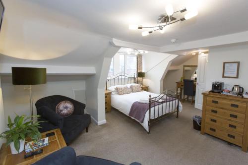 a living room with a bed and a couch at Rosslyn House in Whitby