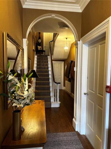 a hallway with a spiral staircase in a home at Rosslyn House in Whitby