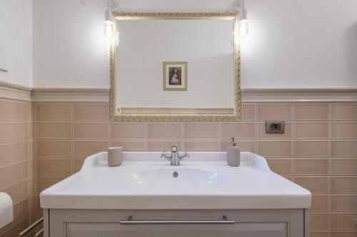 a bathroom with a white sink and a mirror at Brand New !!! Ancient BOLOGNA Centrale LIBERTY Style Completely RENOVATED 2025 in Bologna