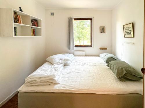 Postel nebo postele na pokoji v ubytování Ferien auf Husarö, Ullas Haus