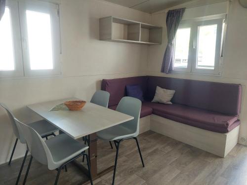 a living room with a couch and a table and chairs at Camping Al Lago Ledro in Ledro